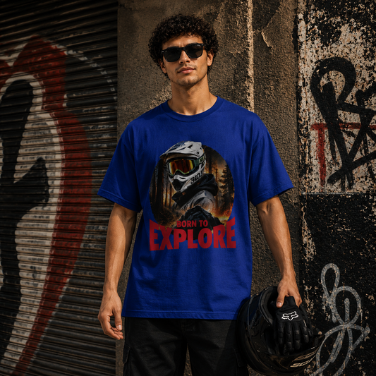 Rider wearing the Born to Explore adventure rider t-shirt in blue, helmet graphic on an adventure landscape