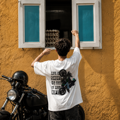 Model wearing the Grip It and Rip It oversized biker t-shirt in white, front and back artwork shown
