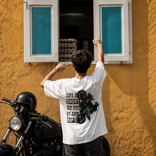 Model wearing the Grip It and Rip It oversized biker t-shirt in white, front and back artwork shown