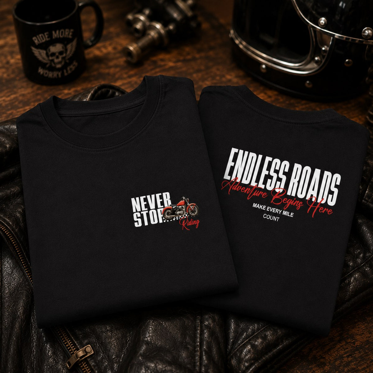 Black Endless Roads oversized biker t-shirt folded, showing Never Stop Riding chest print and back design.
