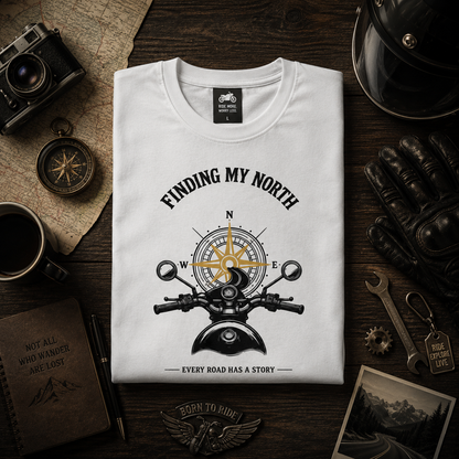 Folded white Finding My North premium biker T-shirt featuring compass and motorcycle illustration.